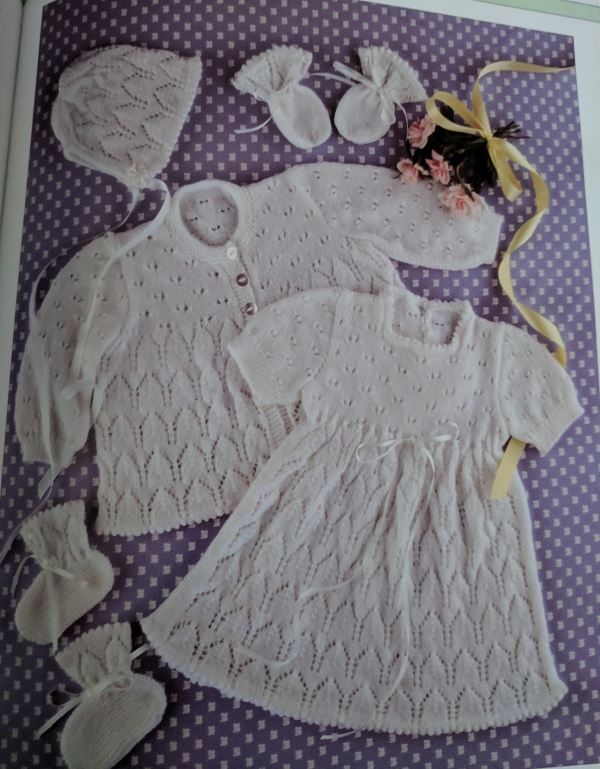 Baby knitting pattern set with lace mitss, dress, booties and jacket